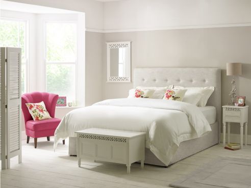 The Ellis modern storage bed, shown in an white-grey Havana Alabaster linen fabric and hand-sewn line of buttons across the headboard.